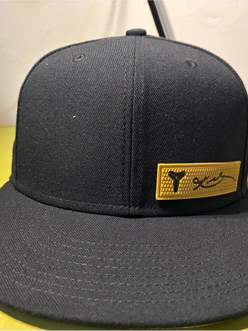 Black Snapback Hat with Gold Logo Patch